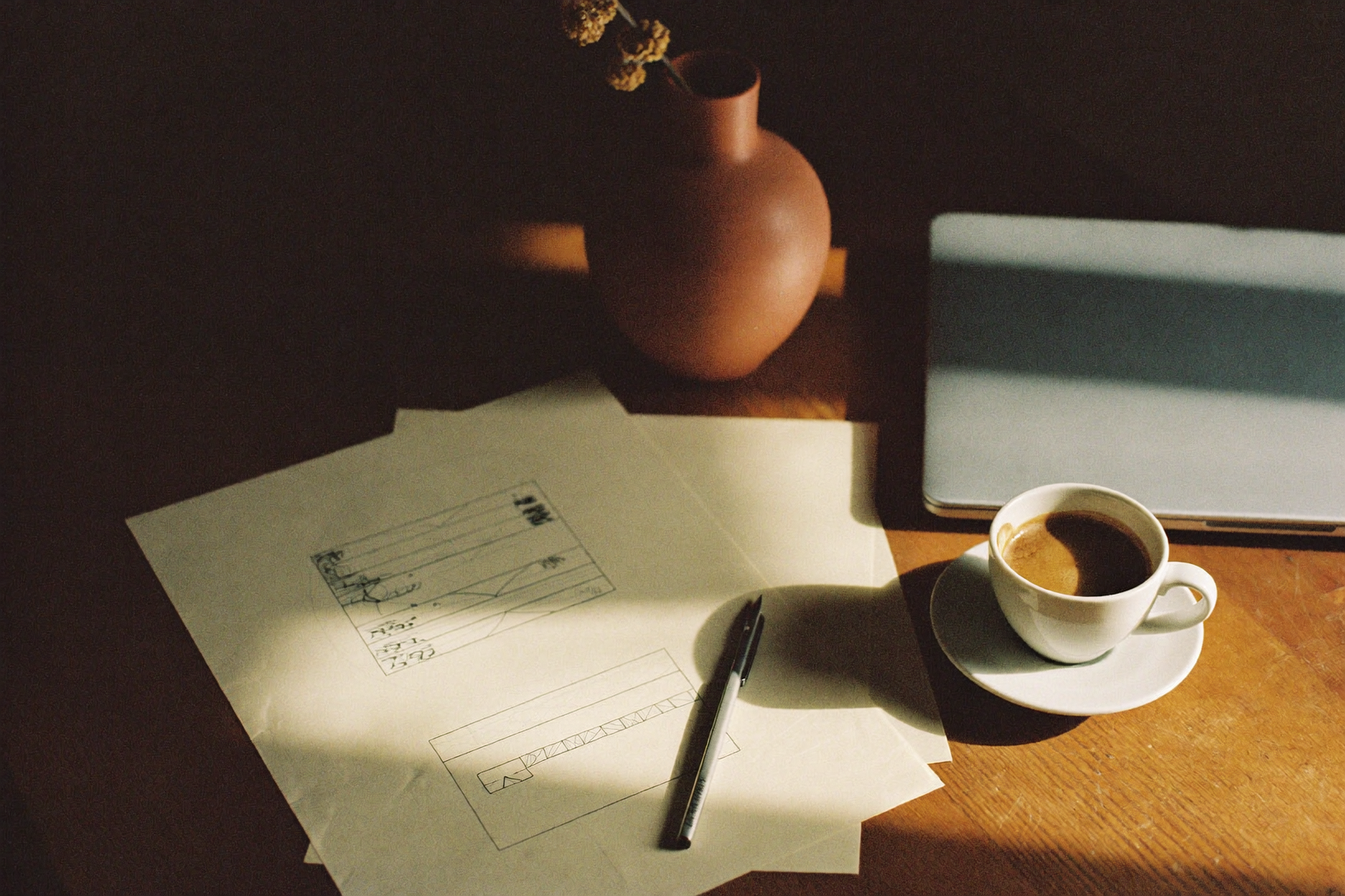 Warm studio desk — where the work happens